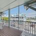 Bridgewalk, a Landmark Resort in Bradenton Beach balcony with table and chairs overlooking waterfront buildings