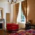 YXIE - manoir des arts in Villeblevin, elegant lounge with red armchairs, fireplace and tall windows