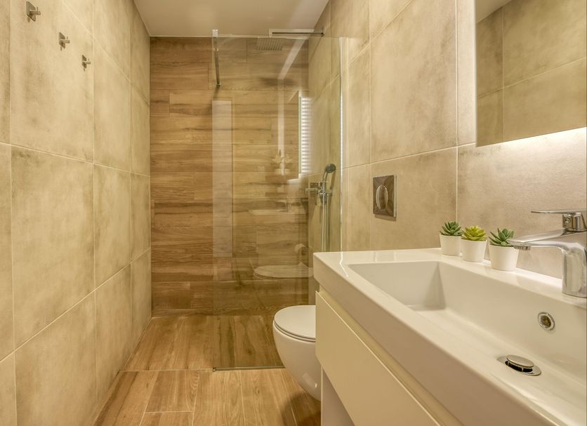 Kaliviani Traditional Hotel in Kissamos bathroom with walk-in shower, vanity sink, and toilet