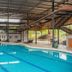 Rain Tree Khao Yai Hotel in Pak Chong: covered indoor swimming pool with lounge chairs