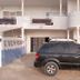 Eden Beach Saint-Louis exterior with a black SUV parked in front of the hotel entrance.