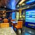 In One City Inn, Taichung City hotel lounge with tables, orange chairs and illuminated display cases
