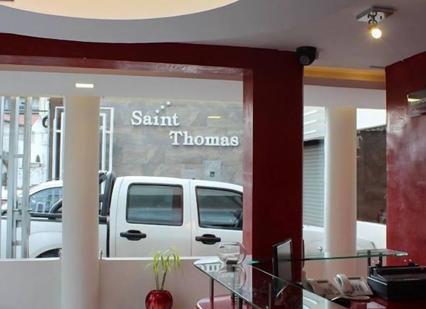 Hotel Saint Thomas in Quito reception area with glass desk and street view through front window