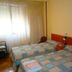 Pension Mari Asun, Pamplona: twin room with two single beds beside a window with sheer curtains