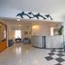 Dolphin Hotel Skopelos lobby with curved reception desk, blue sofa, tile floor and dolphin wall decor