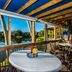 Trianon Bonita Bay Hotel in Bonita Springs patio dining with lake view and palm trees