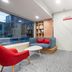 ibis Beijing Dongdaqiao lobby with red chair, blue sofa, white table, and marble-style wall in Beijing