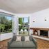 Hotel Mas Djoliba in Antibes lounge with bay windows, garden view, and fireplace