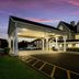 Red Roof Inn & Suites Knoxville East in Knoxville, lit exterior entrance at dusk