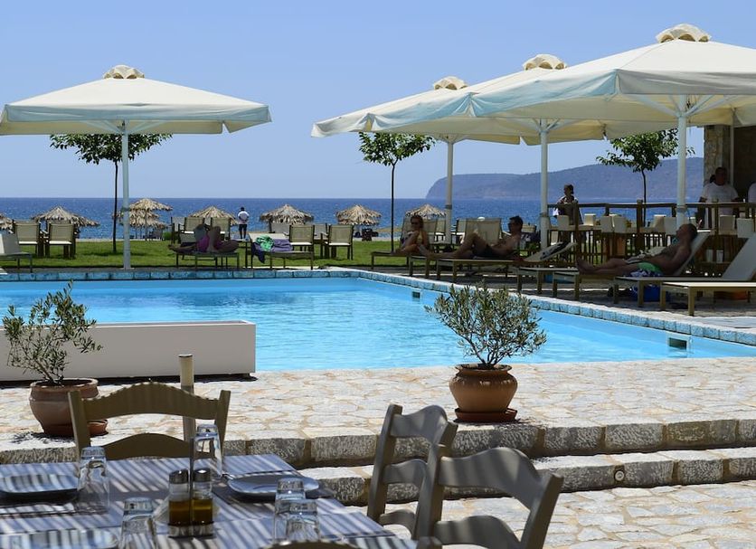 Castello Antico Hotel in Gytheio with outdoor pool, sun loungers, umbrellas, and sea views