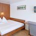Aarauerhof - Self Check-in in Aarau room with double bed, desk, chair and wall-mounted TV
