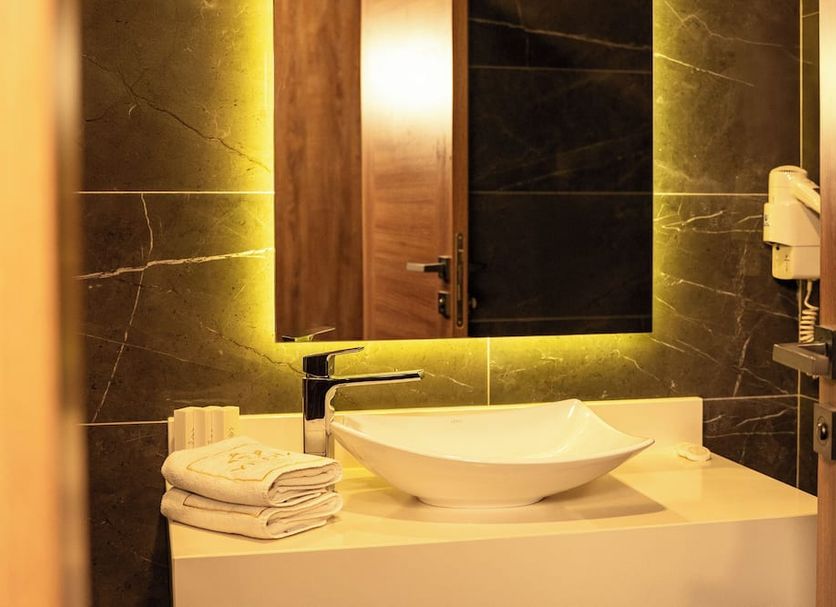 Yildiz Life Hotel in Trabzon bathroom vanity with vessel sink, mirror, towels and wall-mounted hair dryer