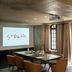 Hôtel Saint-Delis meeting room in Honfleur with projector screen, conference table and tall windows