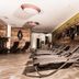 Pension Kreuzjoch in Zell am Ziller spa relaxation area with lounge chairs and rustic wood wall