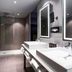 Novotel Resort & Spa Biarritz Anglet bathroom with double sinks, walk-in shower and illuminated mirrors in Anglet