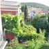 Olea Leya Hotel in Ayvalik with lush garden, hillside view, and surrounding houses