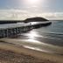 Matador Motor Inn in Coffs Harbour with pier over calm beach and sunlit ocean view