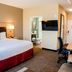 TownePlace Suites by Marriott Temple guest room with king bed, desk, wall TV and doorway to bathroom