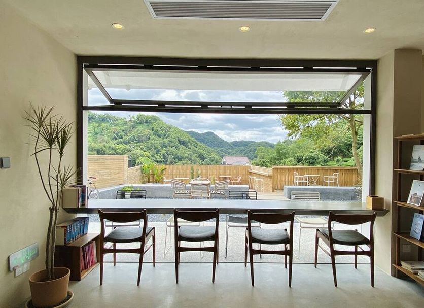 Sansu Hotel Hangzhou in Hangzhou lounge with bar seating and mountain view through large windows