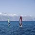 Windsurfers on the sea near mountains at Hotel Torre Oliva in San Giovanni a Piro