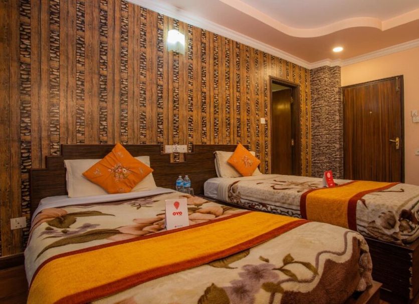 OYO 11457 Kathmandu Resort Hotel in Kathmandu twin-bed guest room with patterned bedding