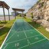 Westgate Branson Lakes Resort in Hollister: outdoor shuffleboard court beside a rocky cliff and benches