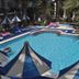 Sami Plaza in Bodrum, outdoor pool with blue-and-white sun umbrellas and palm trees