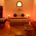 Hotel Spa Casa de Adobe Villa de Leyva room with bed, sofa, wooden floor and warm lighting