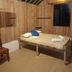 La Villa Creole, Pondicherry: rustic room with a low wooden bed, bamboo walls, and ceiling fan