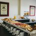 Tagüe in Gualeguaychú breakfast buffet with pastries, coffee cups and juice