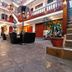Hotel Choquequirao, Cusco: interior courtyard with seating, potted plants, and balcony railings