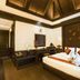 Ao Nang Orchid Resort, Krabi guest room with king bed, wooden ceiling, and dark wood furnishings