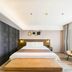 Home Inn Plus Foshan Shunde Qinghui Garden Rt-Mart guest room with king bed, bench, and window seat in Foshan