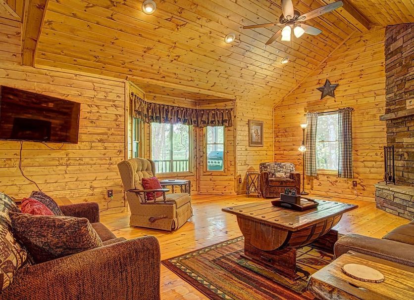 Paradise Hills, Winery Resort & Spa in Blairsville living room with stone fireplace and mountain view window