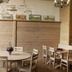 La Ferme De Noémie in Albertville dining room with round tables, wooden chairs, and rustic stone walls