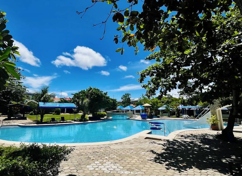 EGI Resort and Hotel in Lapu-Lapu City with outdoor pool, lounge chairs, and tropical garden views