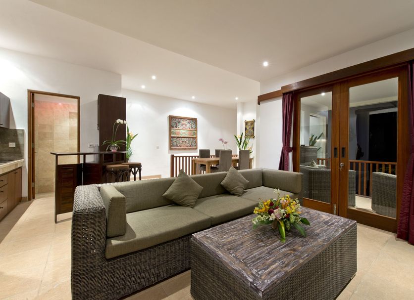 Sahaja Sawah Resort in Tabanan, spacious suite with sofa, coffee table, and balcony doors