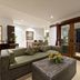 Sahaja Sawah Resort in Tabanan, spacious suite with sofa, coffee table, and balcony doors