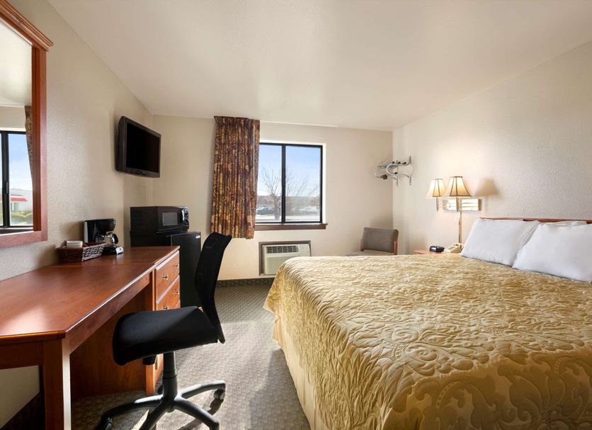 Super 8 by Wyndham Coeur d'Alene guest room with king bed, desk, TV, and window view