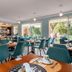 Deltour Hotel Le Puy En Velay dining room with teal chairs and large windows in Le-Puy-en-Velay