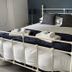 The Green Man, Rugby: white metal bed with dark bedding and folded towels in a guest room