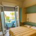 Hotel & Residence Parador, Cesenatico: bedroom with balcony overlooking palm trees and sea view