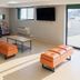 Floral Park Motor Lodge lounge in Queens with sofa seating, TV, and bright windows