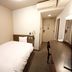 Hotel Route-Inn Iwaki Ekimae single room with bed, desk, air conditioner, and wall art in Iwaki