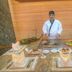 Siji Hotel Apartments in Fujairah buffet chef cooking at a live grill station with plated dishes