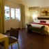 Isabella Boutique Hotel in San Pedro Sula guest room with king bed, bedside lamps and window