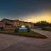 Days Inn by Wyndham Rockdale Texas exterior at dusk with driveway and parking lot in Rockdale
