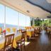 Hotel Miralago in Tremosine dining room with lake view, large windows and yellow table settings