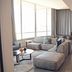The Capital Menlyn Maine, Pretoria: modern suite lounge with sectional sofa, dining table and city-view windows