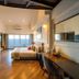 Sinclairs Bayview in Port Blair guest room with ocean view, bed, desk, and staircase